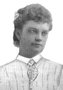 Bertha Crouch, a young white woman with hair in a curly updo, wearing a drawn-on shirtwaist and necktie