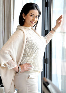 A photograph of Koirala smiling at the camera during promotions for her film Bhoot Returns