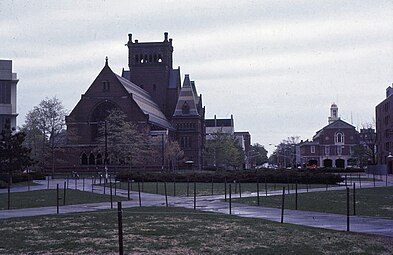 Much of the tower was destroyed in a 1956 fire. The Colonial Revival building at right is a city fire station.