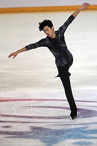 A photograph of Nathan Chen performing on the ice.