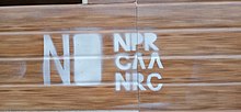 Graffito of NPR-CAA-NRC in spray paint