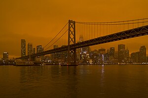 Smoky silhouette of San Francisco under an orange sky