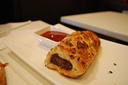 A sausage roll served in-house at a bakery