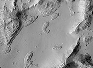 Sulci Gordii Terraced Hills, as seen by HiRISE. Many dark slope streaks are visible.