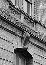 Neoclasiical detail of a building showing the Vitruvian scroll pattern rendered in terra cotta