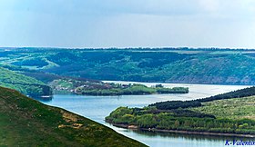 The Dniester River's shore near Bakota's rocky hills.