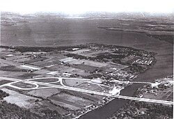 1964 aerial view of Newville with Lake Koshkonong/Rock River in the background. Interstate 90 can be seen in the foreground.