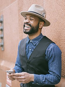 E - A man holding a phone