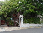 Free-standing single storey vernacular cottage consisting of 'two parallel units each with a half hipped thatched roof; the intervening narrow passage in which the front door is set, is roofed over with a flat roof'; sash windows (24 panes); Type of site: House Current use: House.