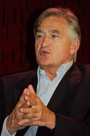 Colour photograph of Antony Beevor in dark jacket, without tie, speaking at a meeting