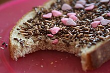 Picture of bread, topped with chocolate jimmies and pink heart-shaped candies