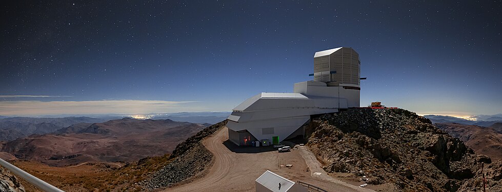 Night Light over Vera C. Rubin Observatory with the brightening of the sky due to the artificial light that can be seen as clusters of bright lights on the horizon