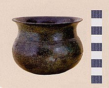 Fused bronze drinking vessel serving as a cinerary urn, "Golasecca II A" period.
