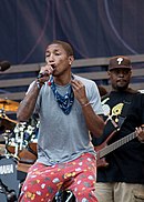 Pharrell Williams singing onstage.