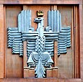 Polish coat of arms (unofficial) in Art Deco style, on the façade of the post office in Warsaw (architect Julian Puterman-Sadłowski, 1934)