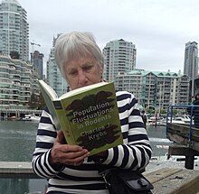 Judy (Judith) Myers reading one of Charles Krebs books in downtown Vancouver