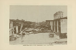 A scene of the damage from the 1928 Okeechobee Hurricane in West Palm Beach, Florida. Houses lay in ruins, while debris covers portions of the streets.