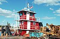 A barge ready to salvage heavy machinery parts and a tugboat named Miss Susan.