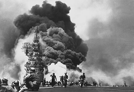 USS Bunker Hill after being hit by two Kamikazes, by United States Navy