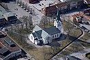 A white church with blue roof seen from the sky