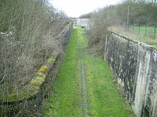 Allée d'herbe entre deux murs de pierre