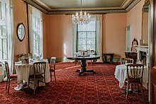 Overnewton Castle has a large sitting room with ornate fireplaces that connects to a parlour room. Now it acts as a dining room for guests