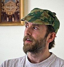 Varg Vikernes in his mid-thirties wearing a camouflage hat