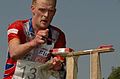 Orienteer using a SPORTIdent control card at a control point that has a needle punch for backup