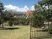 A circle of flags at the entrance to Garden of the Gods in Colorado, Springs, Colorado. The flags of Russia, Greece, and the Republic of China are visible in the foreground, just downhill from the gates to the parking lot.