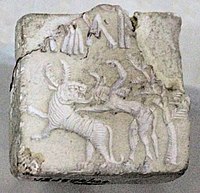 Fighting scene between a beast and a man with horns, hooves and a tail, who has been compared to the Mesopotamian bull-man Enkidu.[77][78][79] Indus Valley Civilisation seal.