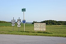 Road signs pointing to routes 235 and 207, as well as interstate 89 and the towns of Franklin and Highgate.