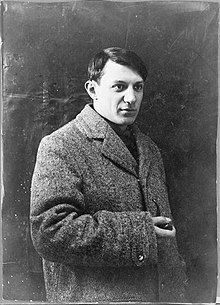 Black-and-white photo of Picasso in a coat