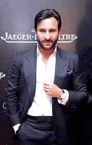 A young, bearded Saif Ali Khan in a grey pinstriped suit