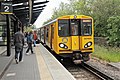 A Merseyrail Class 507 arrives with a service from Liverpool.