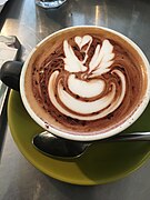 A caffè latte featuring latte art