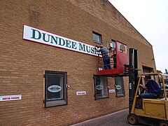 Installation of the museum sign outside the home of the Dundee Museum of Transport