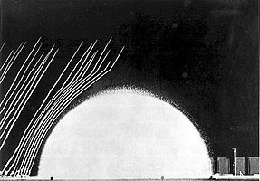 Detonation of 20 tons of propane-oxygen hemisphere in Event 2A. The blast wave can be seen affecting the smoke trails.