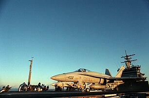 An F/A-18A Hornet of VFA-161 prepares to launch from USS Enterprise while an F-14A waits behind. CVW-10 was on board Enterprise in 1987.