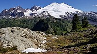 Snow-capped mountain in background with rocky path in foreground