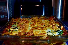 Vegetarian lasagna made with tomato sauce, spinach, feta, carrots, mushrooms and grated Emmental