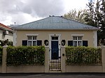 Free-standing single storey vernacular cottage; double pitched full hipped corrugated iron roof; stippled plaster walls with quoining at corners and moulding around front door; double casement windows with fanlights and louvred shutters; Victorian sash Type of site: House Current use: House.