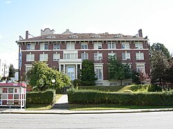 An imposing brick building on a hill with "YWCA" above the entrance.