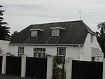 Free-standing single storey cottage with attic presently being extended and replastered; half hipped roof with IBR sheeting; plaster mouldings around openings on front facade; sash windows (24 panes), inappropriate unpainted shutters and new casement. Type of site: House Current use: House.