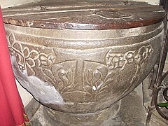 Baptismal font (14th century) at Fivizzano with the Saint Anthony's cross symbol of the Antonine canons