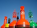 Several different buoys at a storage depot.