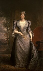 Full-length portrait of First Lady Harrison wearing an elaborate gown, facing the side and holding a fan