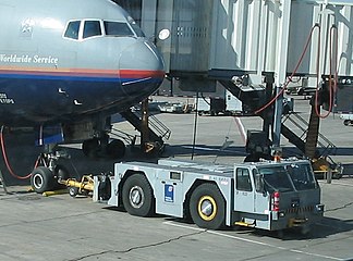 Pushback using a conventional tractor tug hooked up to a United Airlines Boeing 777-200ER at Denver International Airport, Colorado