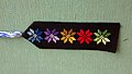 Bookmark of black fabric with multicolored Bedouin embroidery and tassel of embroidery floss