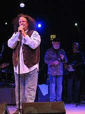 Two men singing on stage