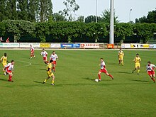 Photographie représentant les joueurs du Racing Club Fléchois en rouge et blanc lors d'une rencontre de championnat au stade Montréal.